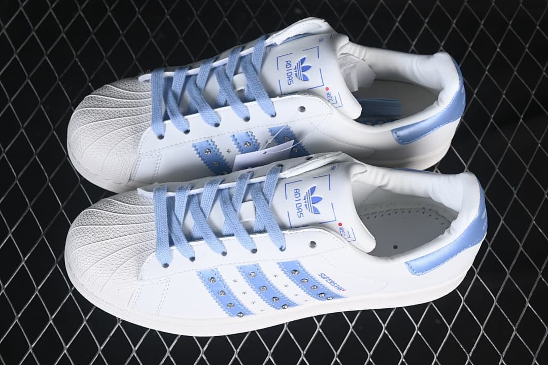 Pair of white and pale blue Superstar II sneakers shown from above.