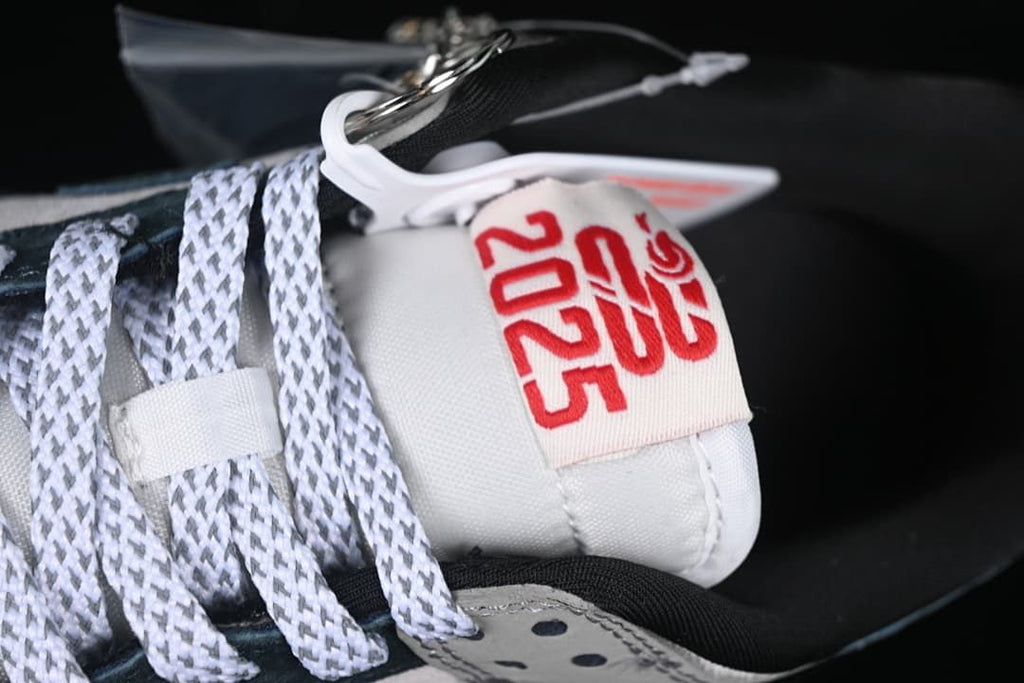 Close-up of the tongue tag with 2025 graphics and attached accessory