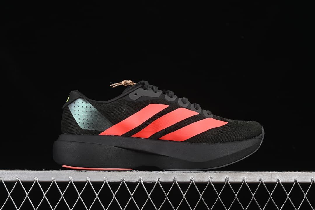 Side profile of the black shoe with coral stripes and a sculpted midsole