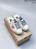 Pair of white backless sneakers with gray laces, pink star detail, and distressed-look soles