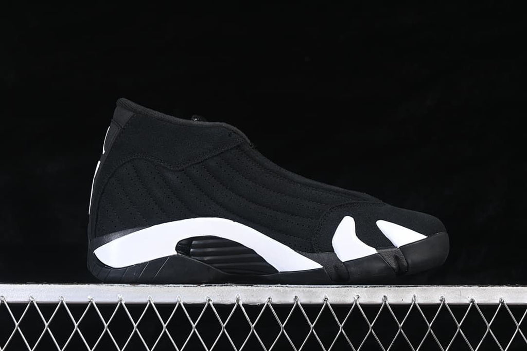 Side profile of a black high-top sneaker with white midsole accents