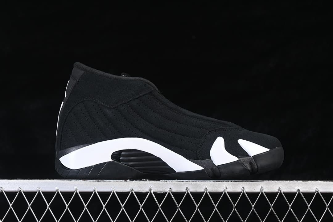 Side profile of a black high-top sneaker with white midsole accents