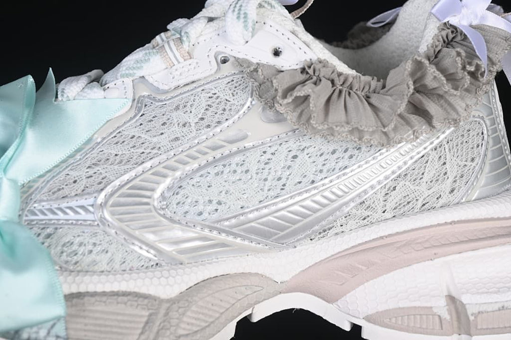 Close-up of the layered mesh-look upper, silver-tone overlays, and ruffle detail