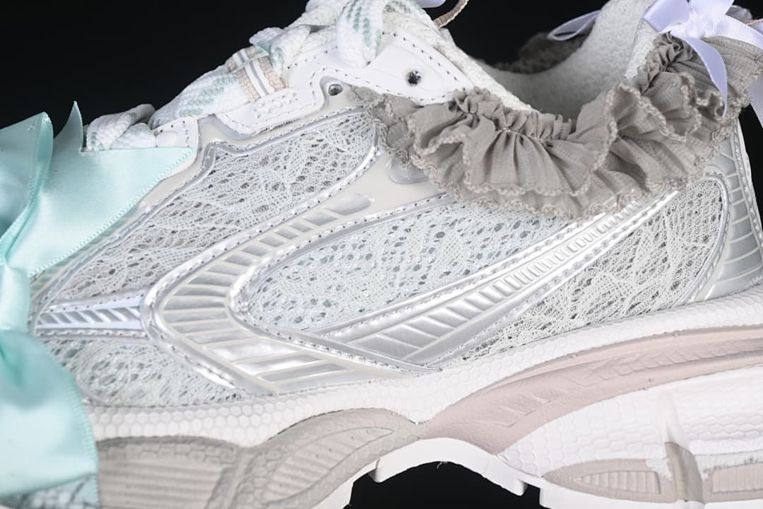 Close-up of the layered mesh-look upper, silver-tone overlays, and ruffle detail