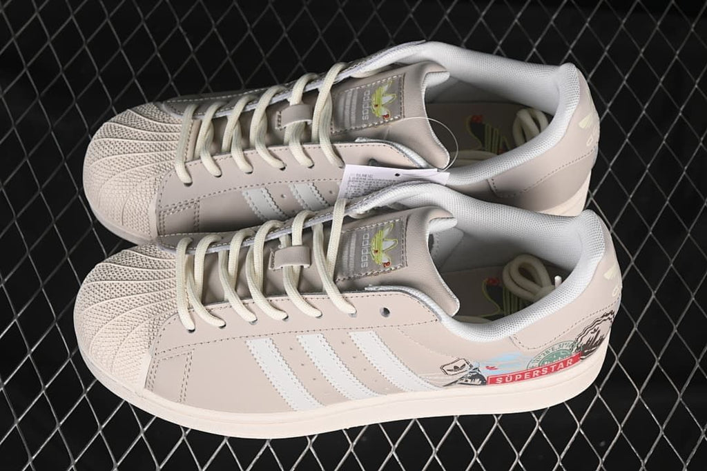 Pair of beige and white Superstar II sneakers shown from above.