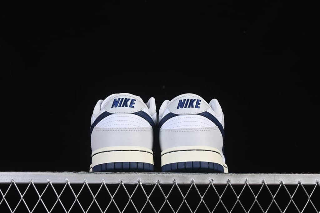 Rear view of both sneakers showing heel panels and navy outsoles