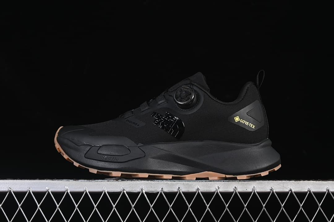 Side view of the black Vectiv Enduris Low shoe with dial closure and tan-toned outsole.