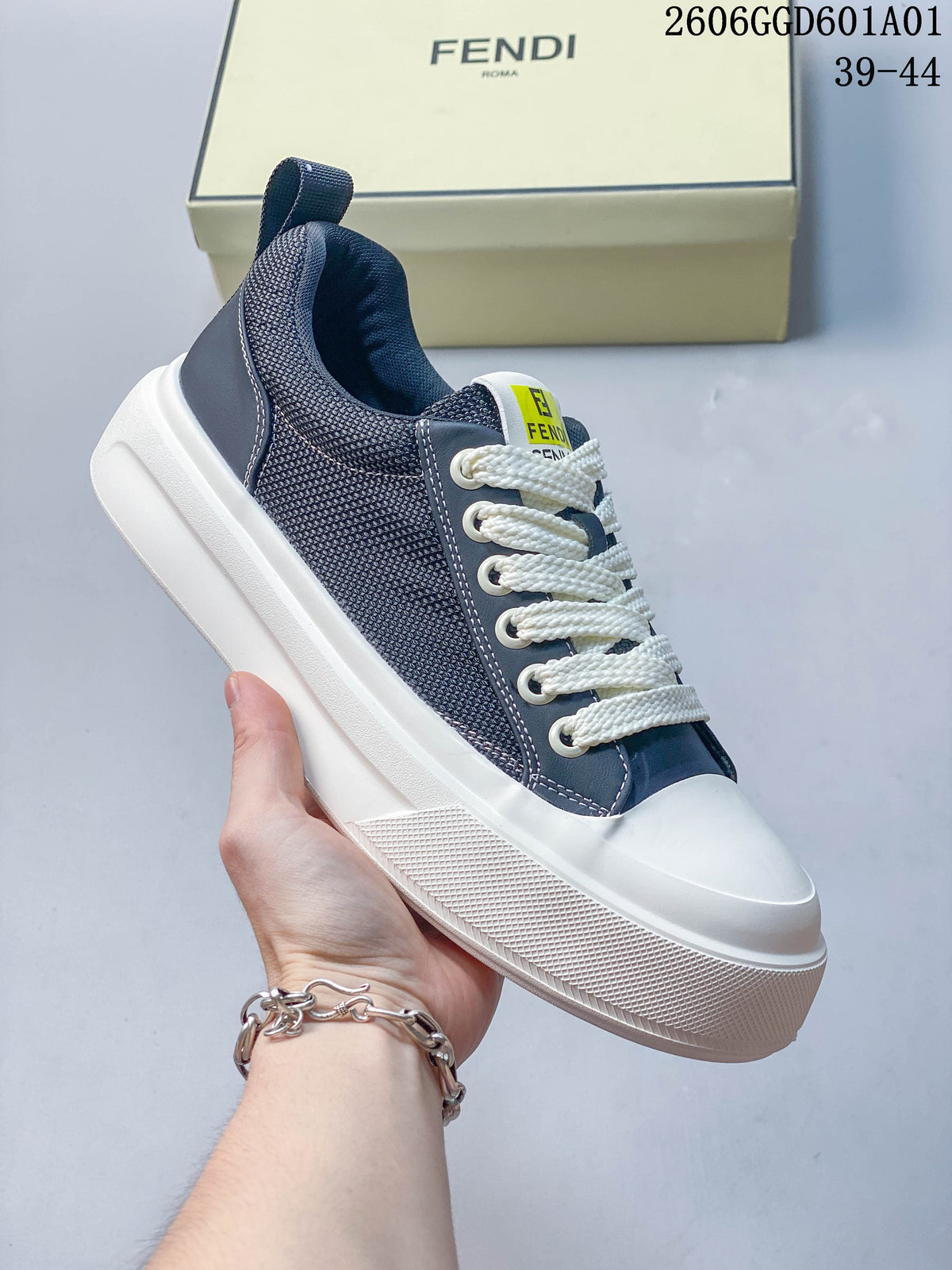 Angled side view of a navy and white Fendi low-top sneaker with textured panels and white laces.
