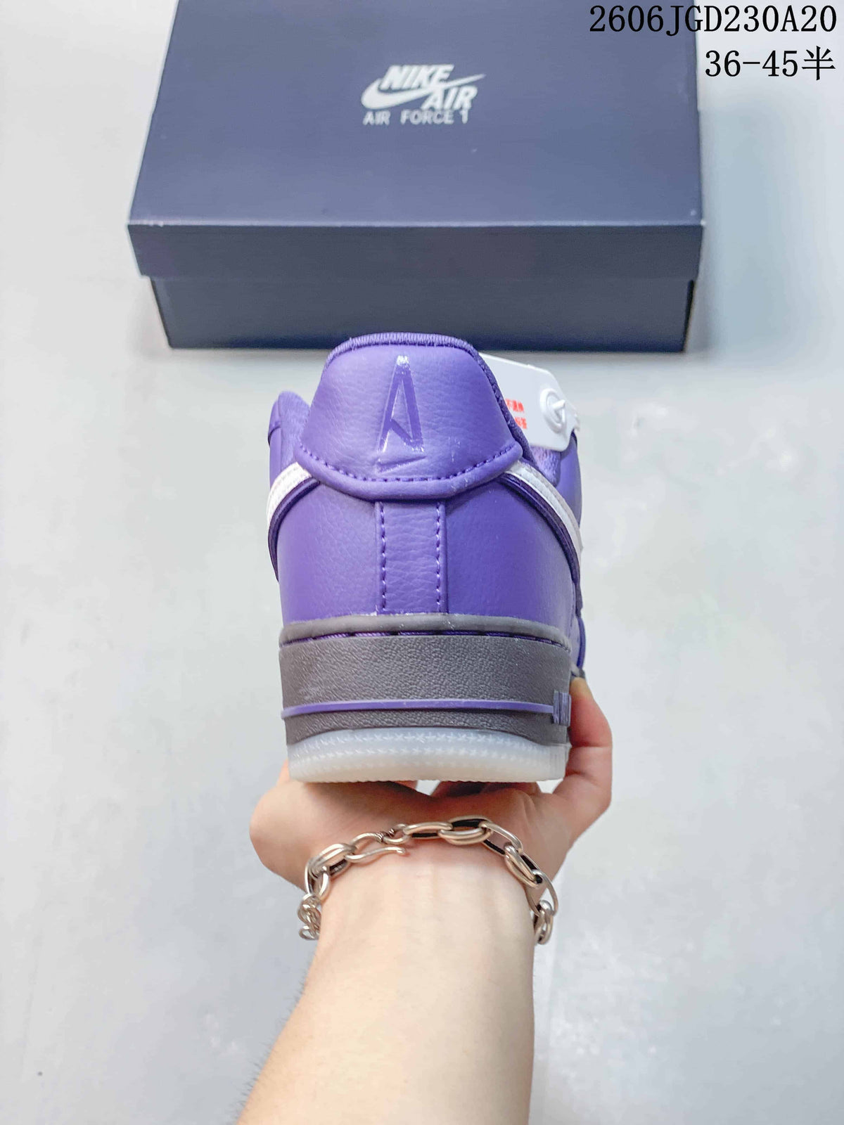Rear view of a purple Nike Air Force 1 sneaker with a gray midsole