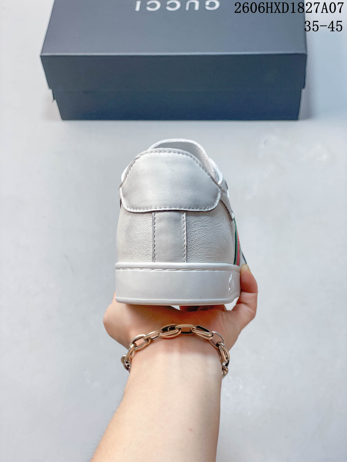 Rear view of a white low-top sneaker with stitched heel panels.