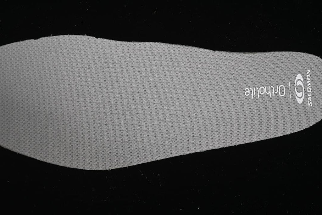 Gray Salomon OrthoLite insole with textured surface
