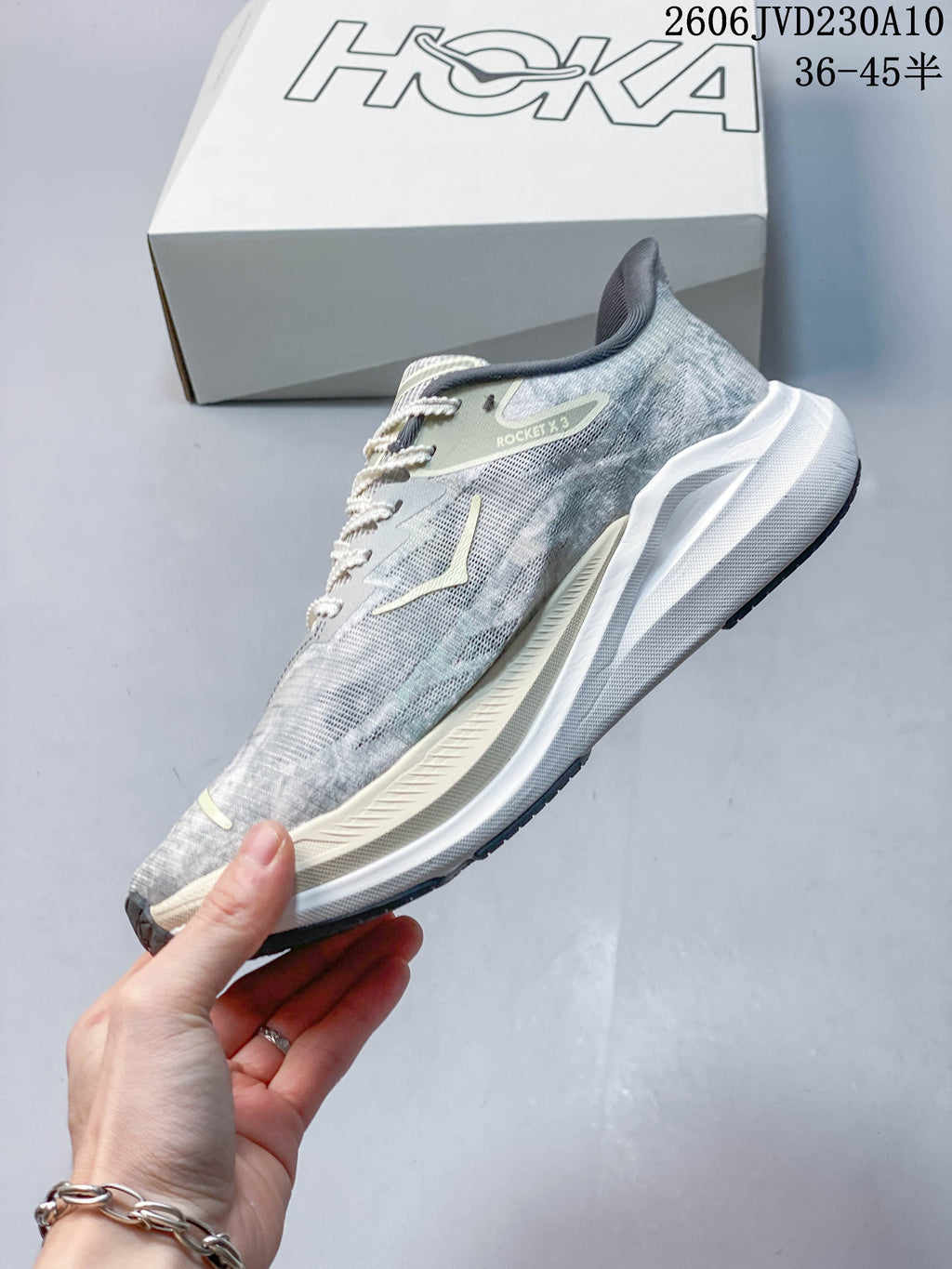 Side profile of a grey HOKA Rocket X 3 running shoe.