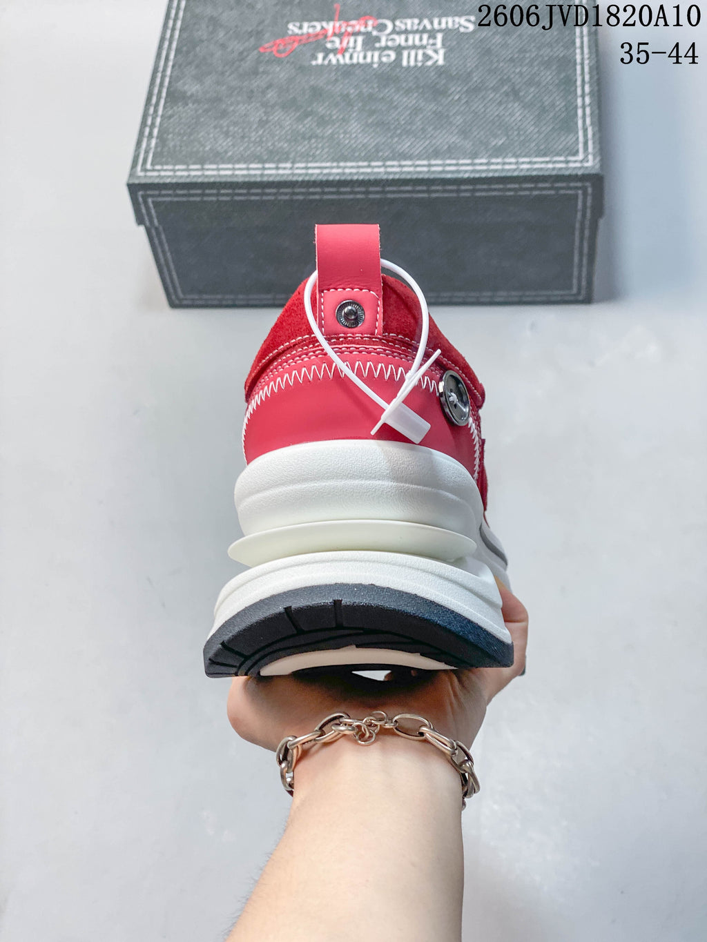 Rear view of a red sneaker showing the heel and layered sole