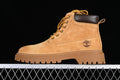 Side profile of a yellow-brown Timberland mid-top boot with a dark collar and lugged sole