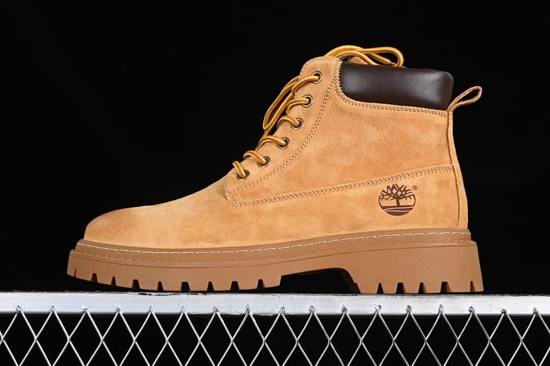 Side profile of a yellow-brown Timberland mid-top boot with a dark collar and lugged sole