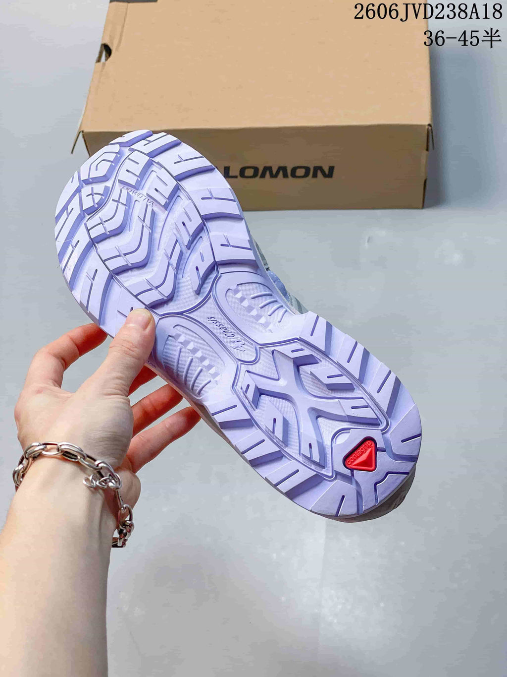 Close-up of the lugged outsole with a red heel detail.