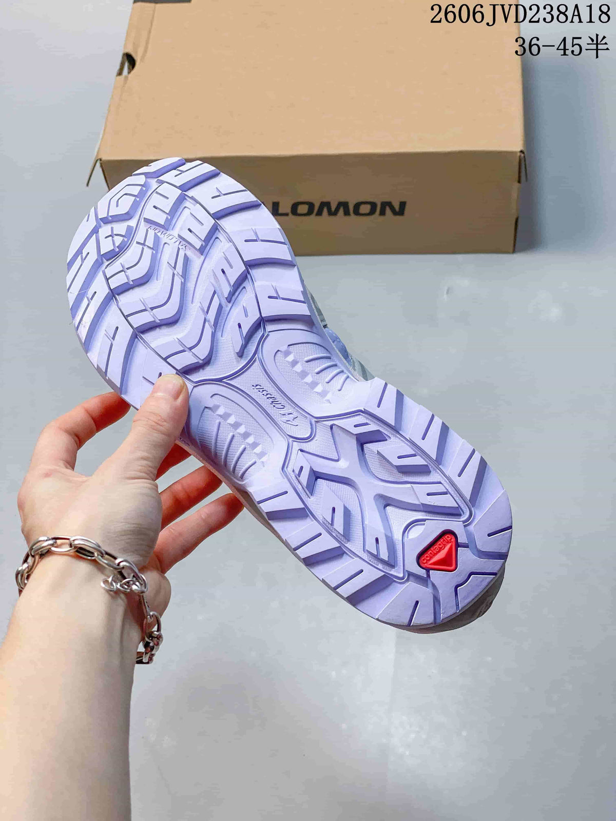 Close-up of the lugged outsole with a red heel detail.