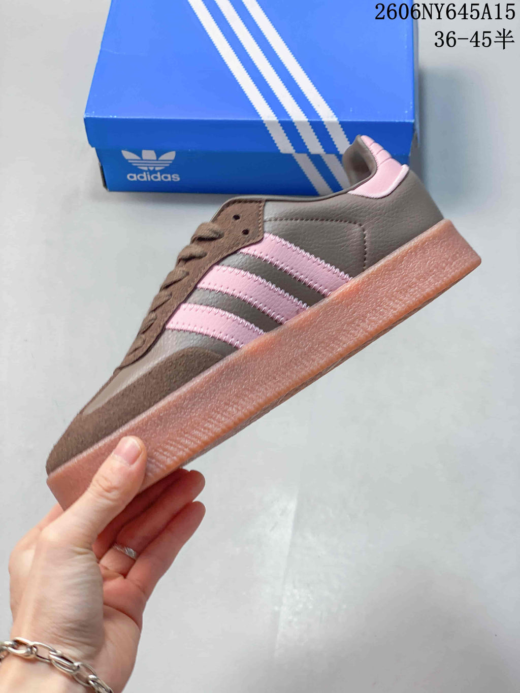 Side view of the brown adidas Sambae with pink stripes and a thick platform sole