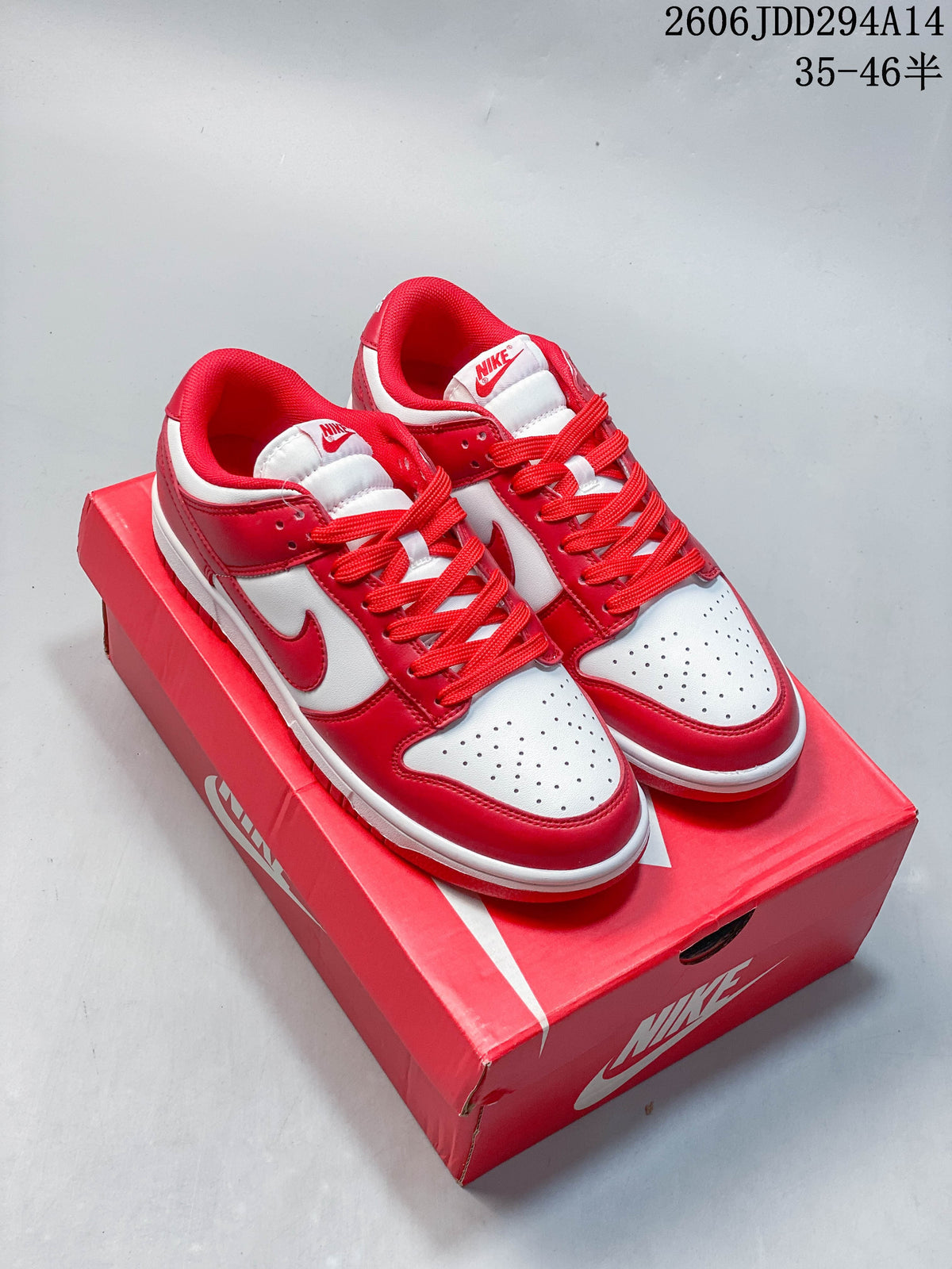 Pair of red and white Nike Dunk Low sneakers shown on a red box.