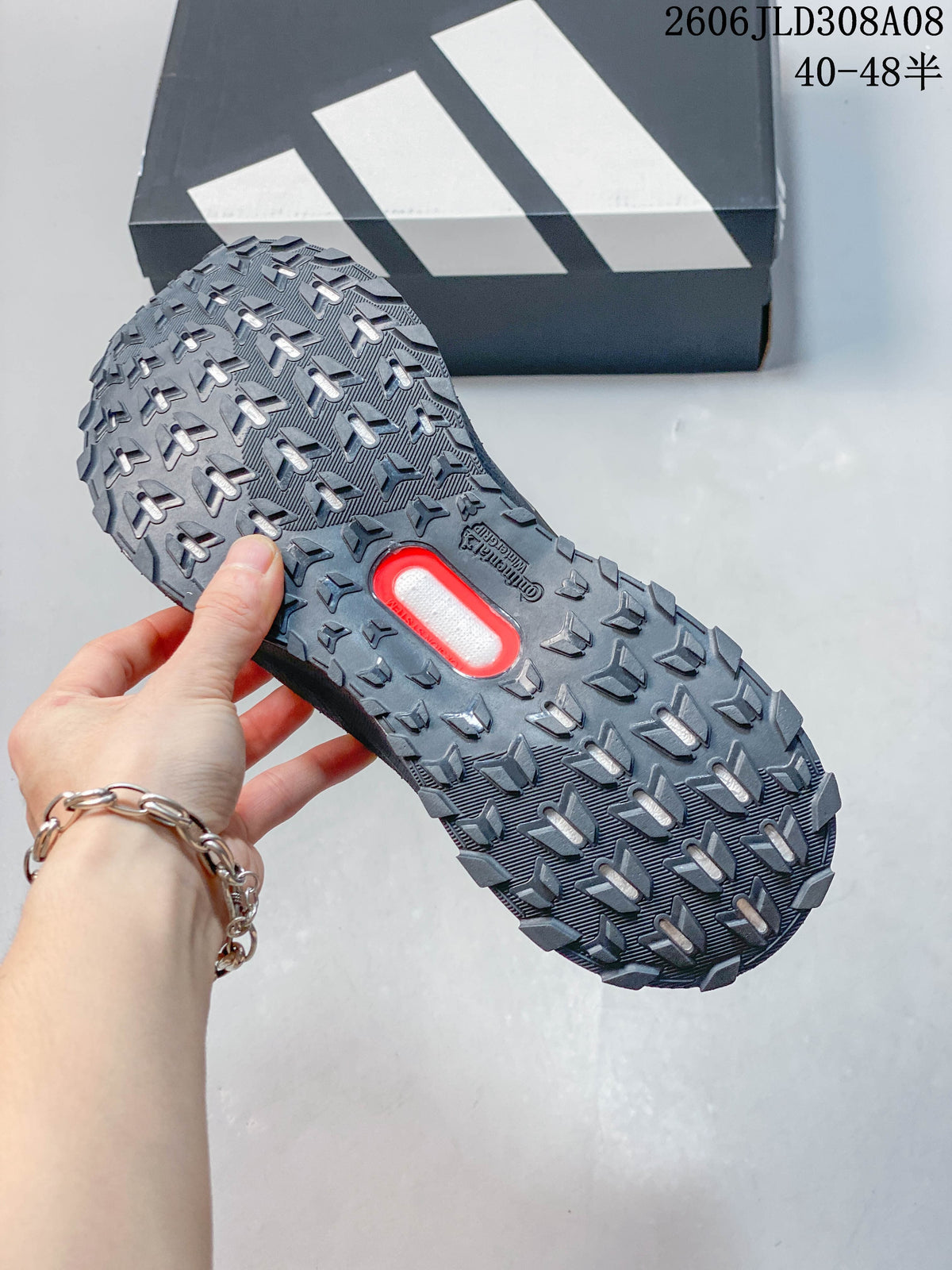 Close-up of the dark gray shoe's lugged outsole.