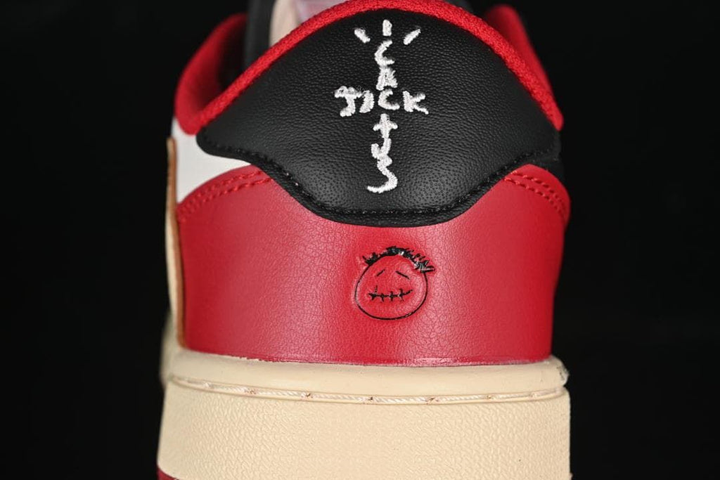 Close-up of red heel panel and black heel tab with embroidered details