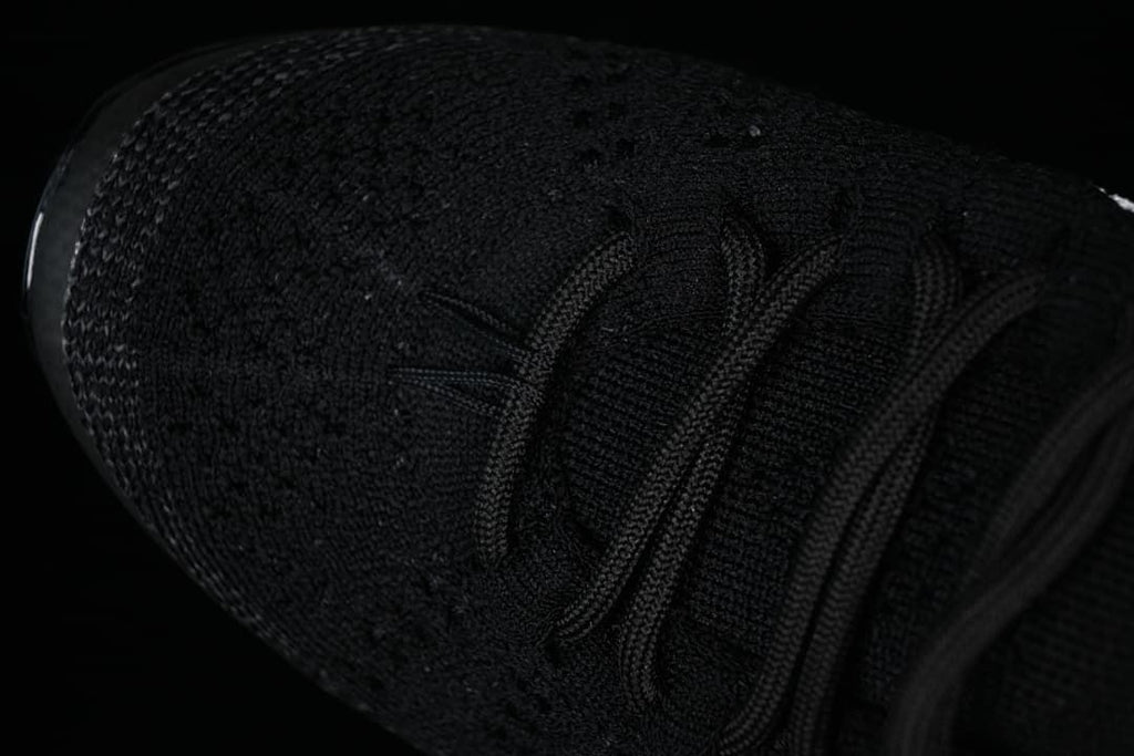 Close-up of the knit-style toe and black laces.