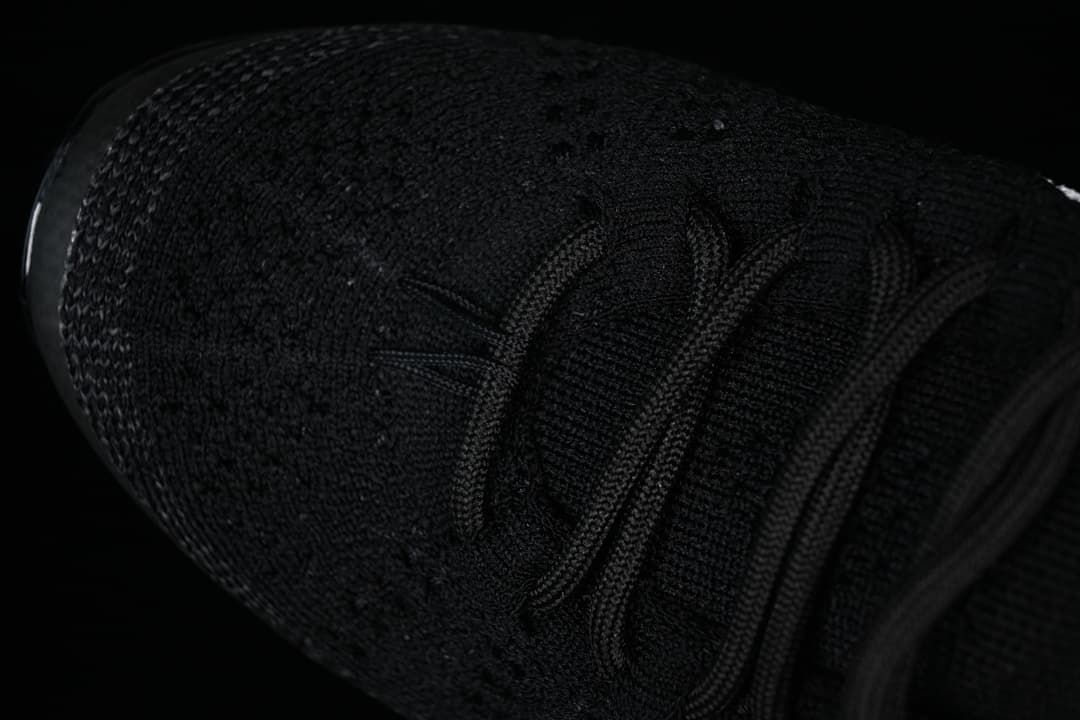 Close-up of the knit-style toe and black laces.
