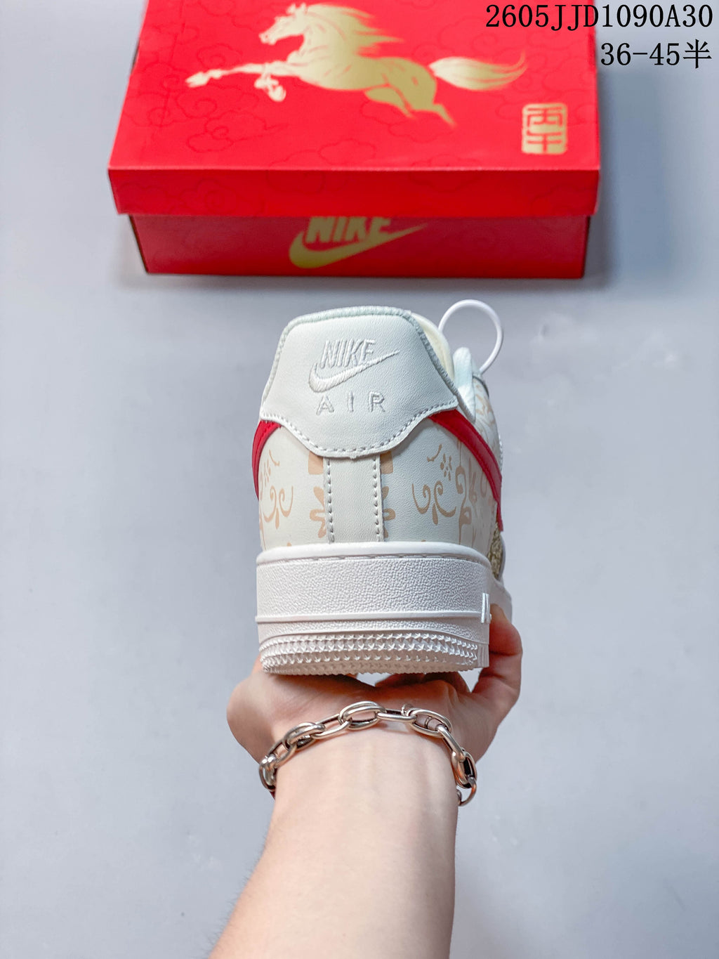 Rear view of the ivory printed sneaker with red accents and white sole