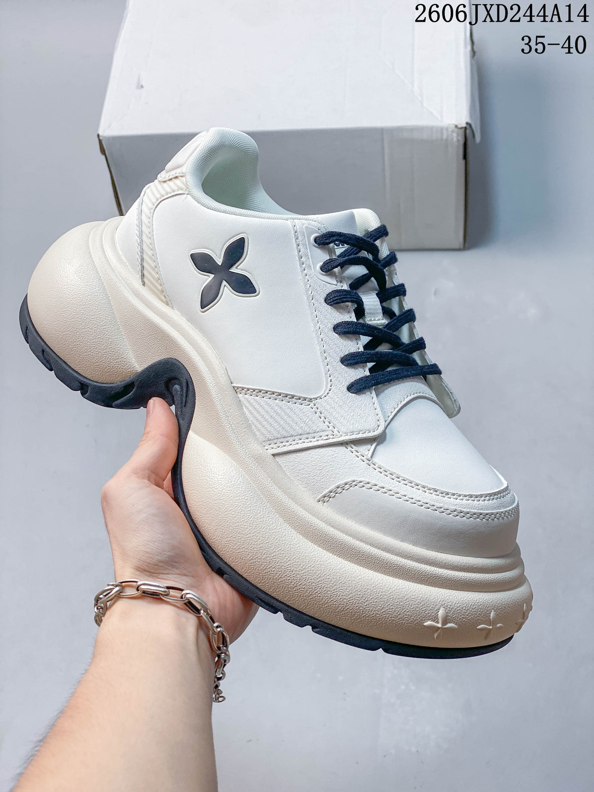 Side view of a white SMFK sneaker with navy laces