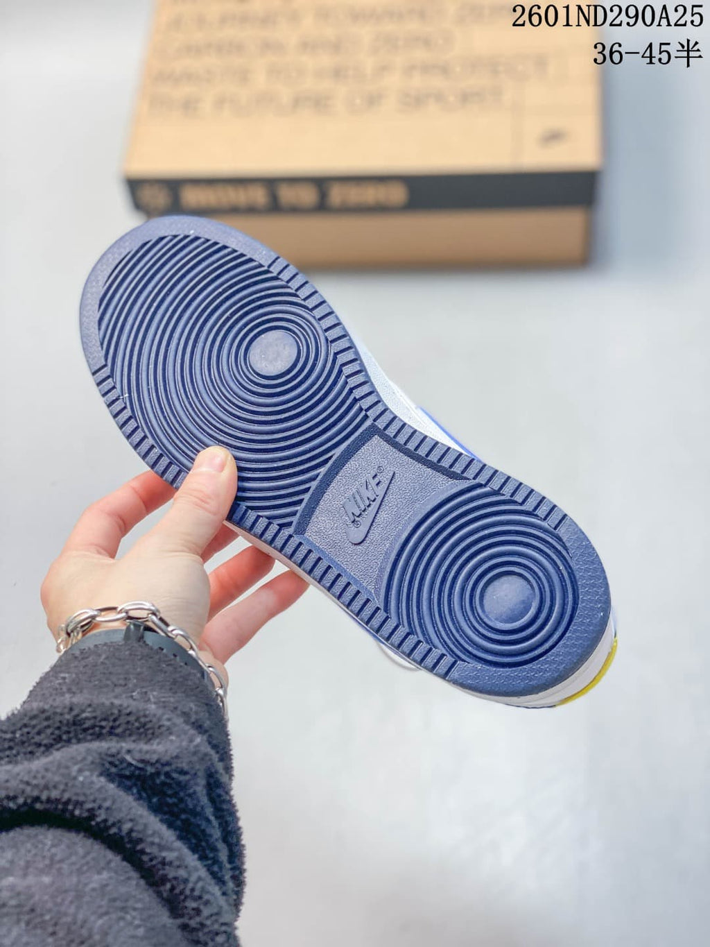 Underside of the sneaker showing a blue circular-pattern outsole.