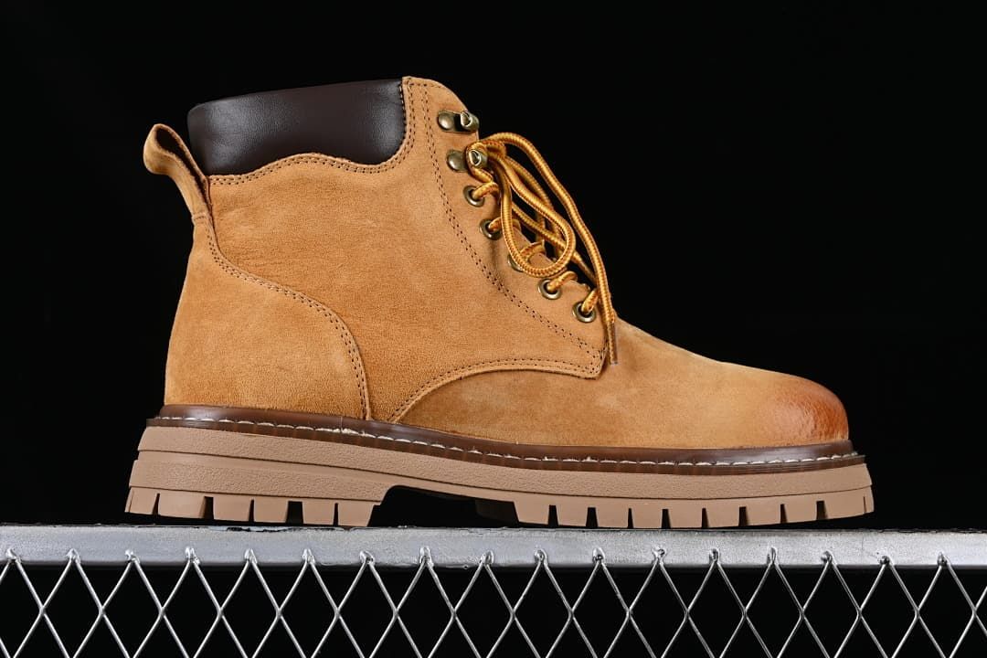 Side profile of a wheat-brown lace-up boot with a dark padded collar