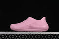 Side view of a pink Nike ReactX Rejuven8 slip-on shoe against a black background.