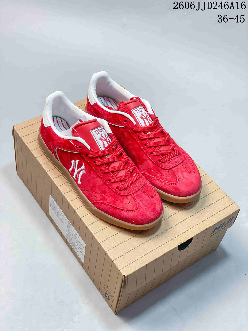 Red New York Yankees low-top sneakers with a gum-colored sole, shown as a pair.