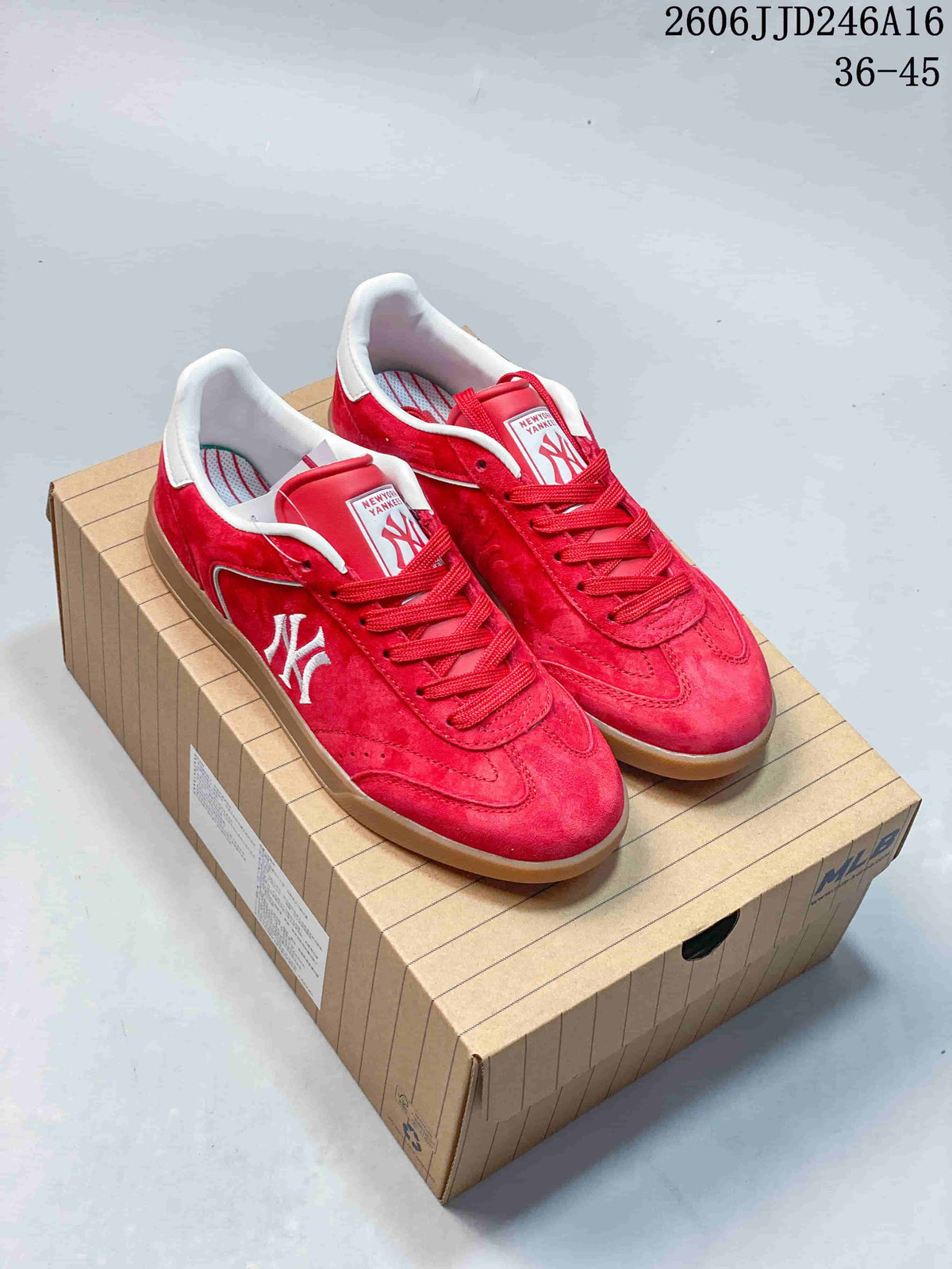 Red New York Yankees low-top sneakers with a gum-colored sole, shown as a pair.