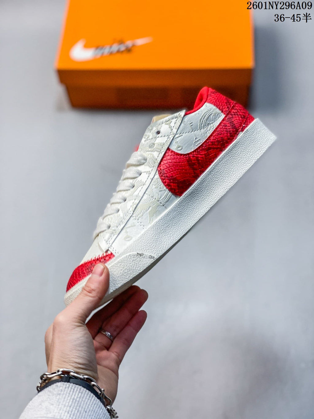 Side view of the white and red low-top sneaker