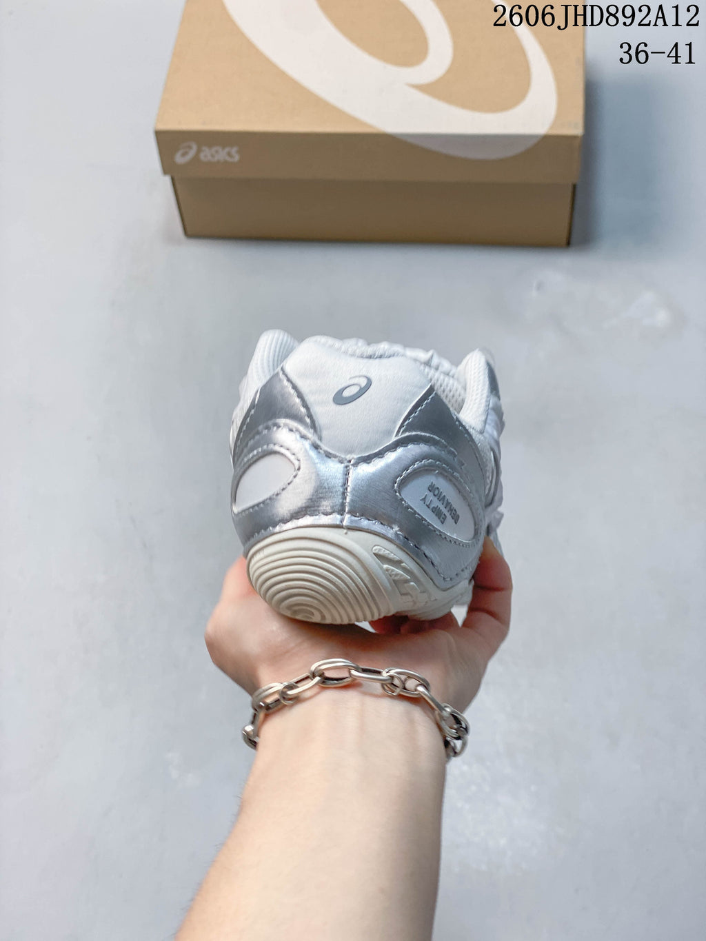 Rear view showing the silver heel panels and ASICS logo