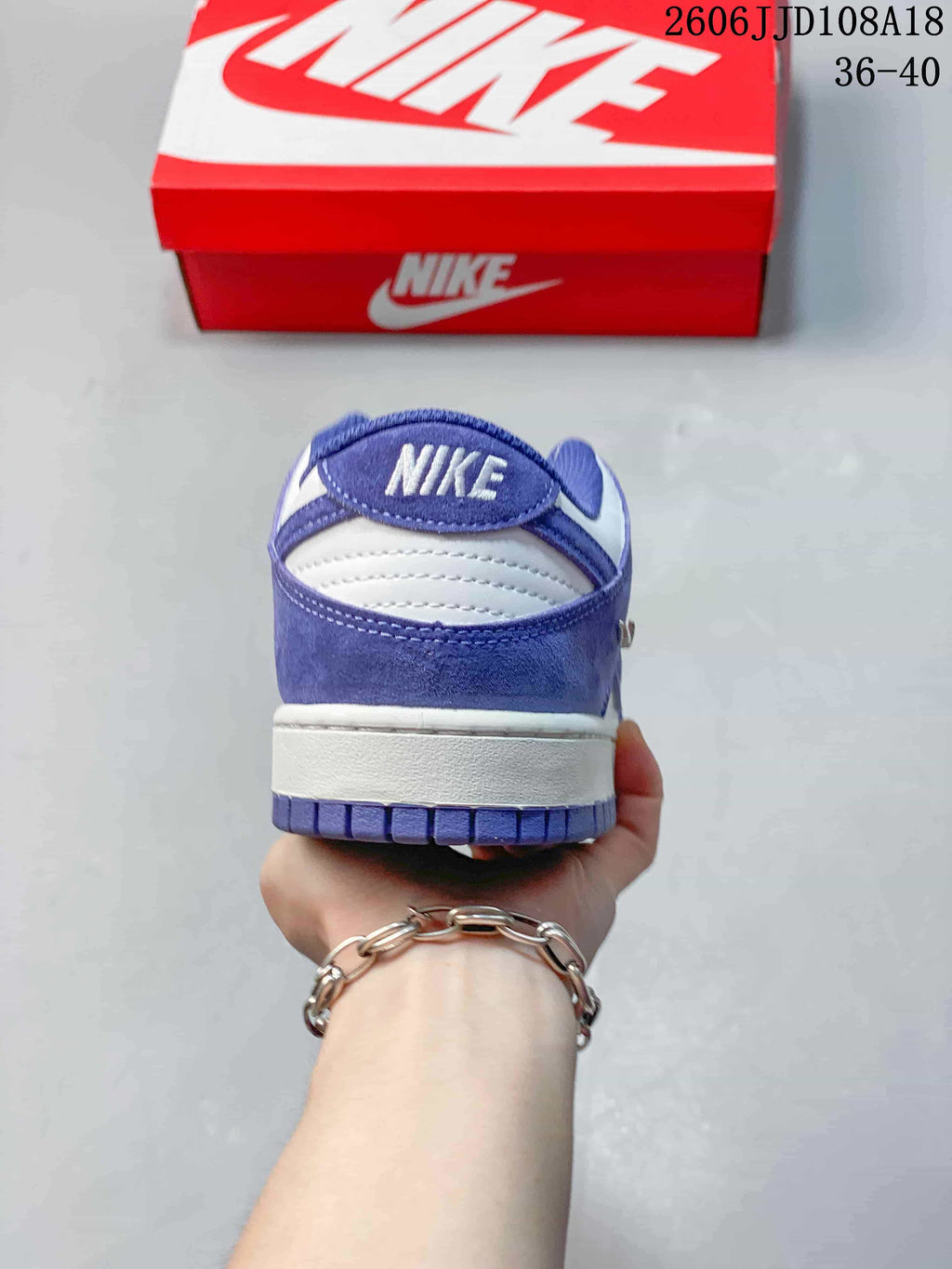 Rear view showing the purple heel panel and white midsole.