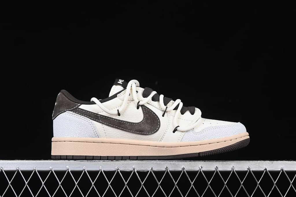Side profile of the low-top sneaker in off-white, dark brown, pale blue, and tan