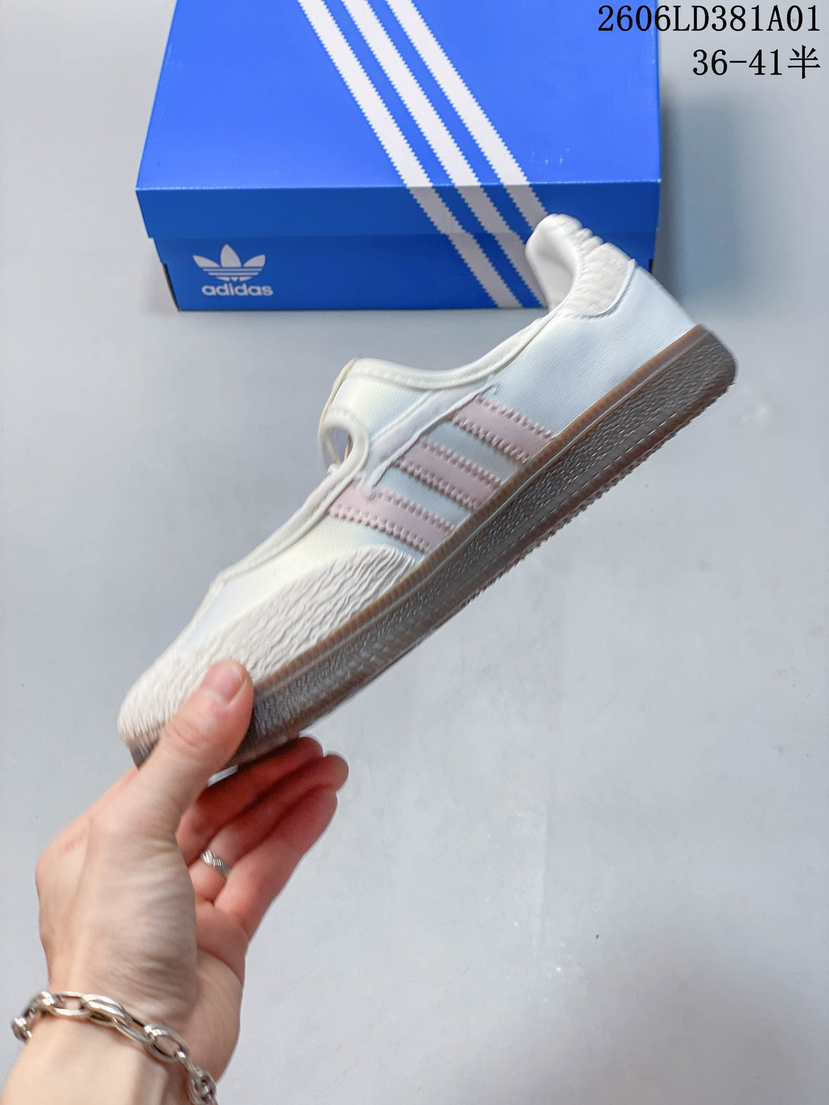 Side profile showing pale pink stripes, an instep strap, and a gum-colored outsole
