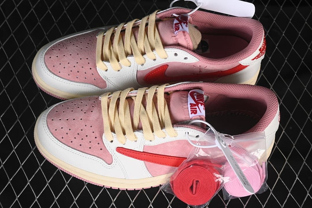 Pair of pink and white low-top sneakers with extra pink laces pictured