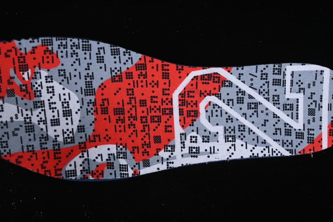 Close-up of a red, gray and black patterned shoe insert