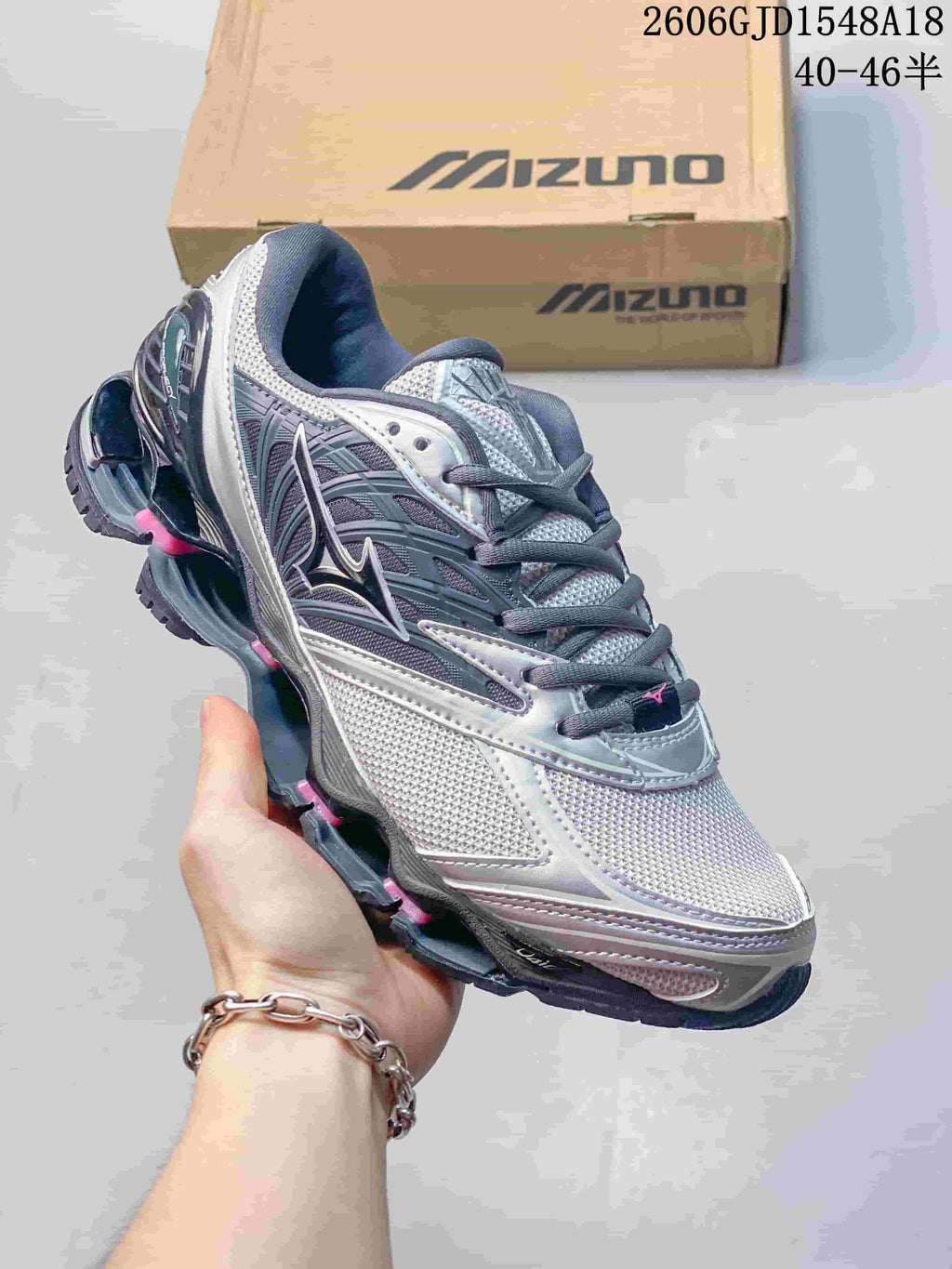 Angled side view of the silver and gray Mizuno sneaker