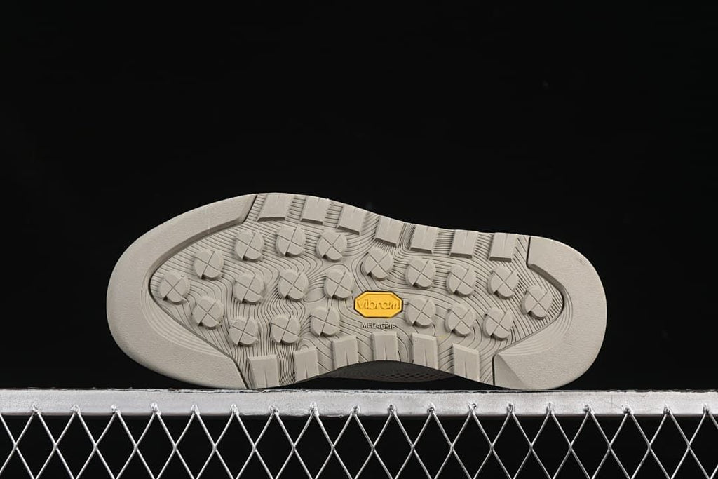 Underside view of the outsole with lug pattern and visible Vibram mark.