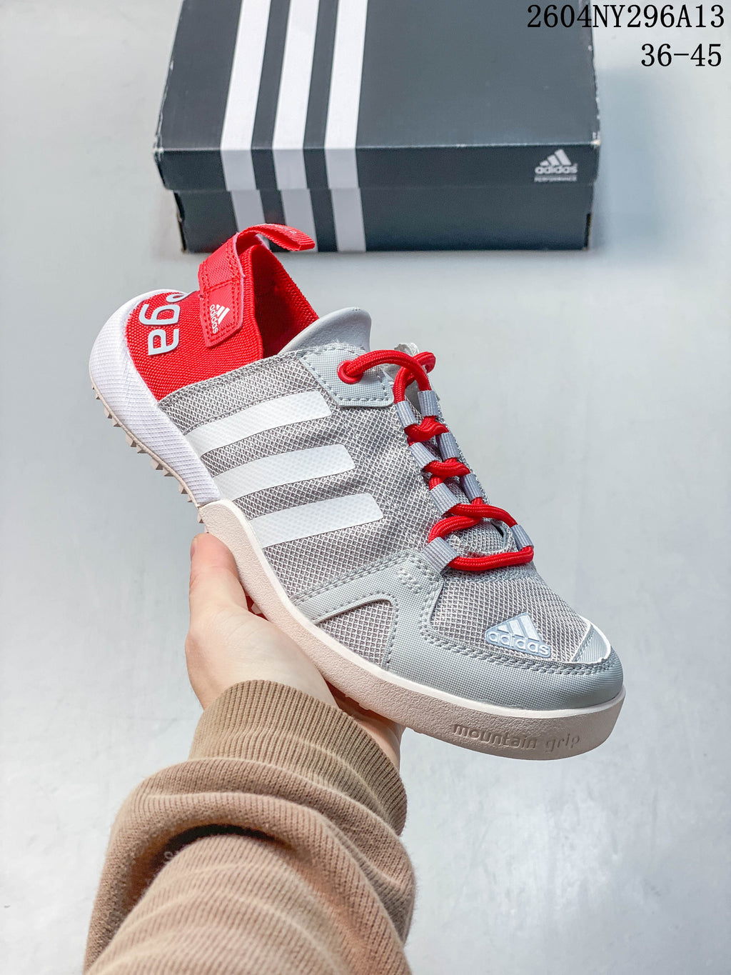Angled side view showing the three white stripes and textured outsole