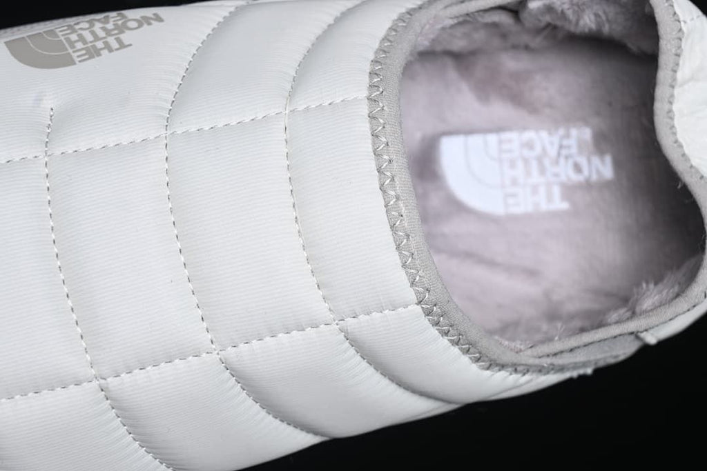 Top-angle detail of the quilted upper and plush interior.