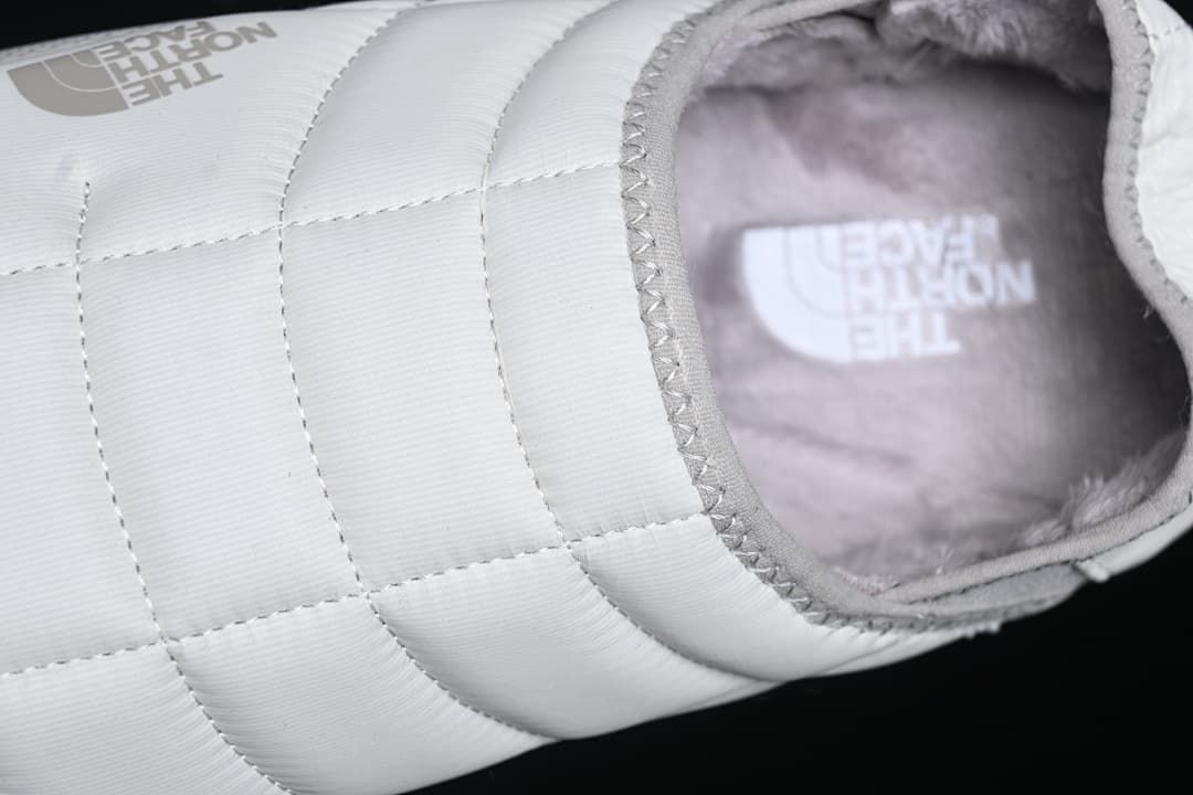 Top-angle detail of the quilted upper and plush interior.