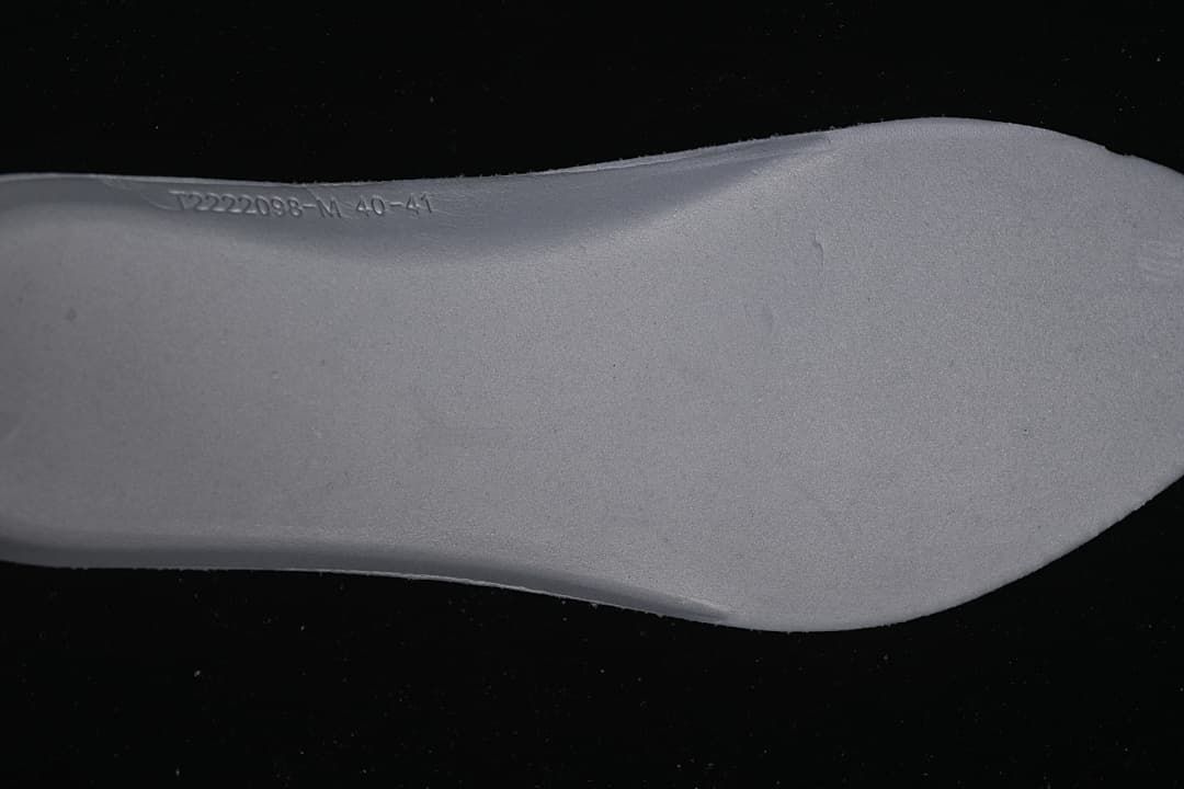 Close-up of the insole with embossed product and size markings.
