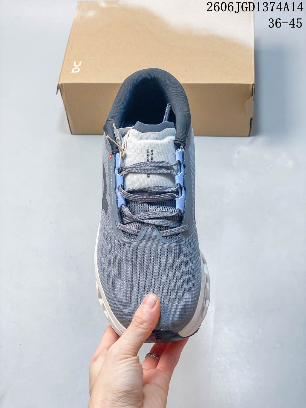 Top view showing the grey laces, tongue and textured upper.