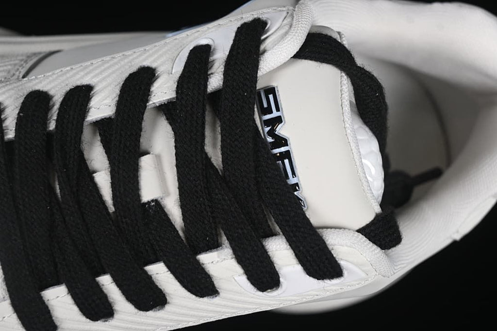 Close-up of black laces and the tongue label