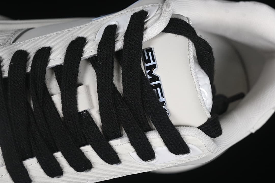 Close-up of black laces and the tongue label